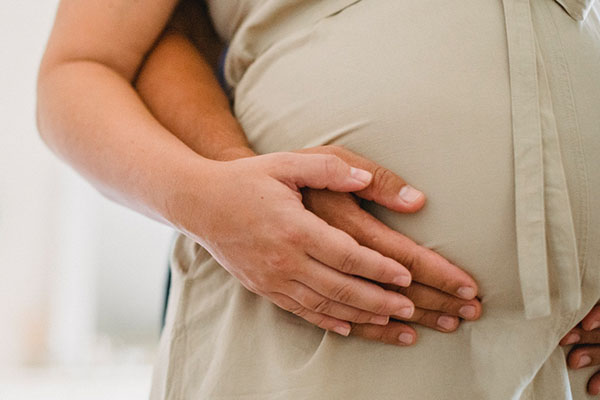 A couple embracing mum's bump